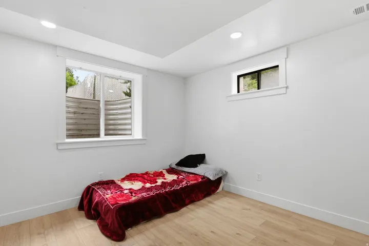 Room featuring light wood-finish flooring, white walls, and recessed lighting