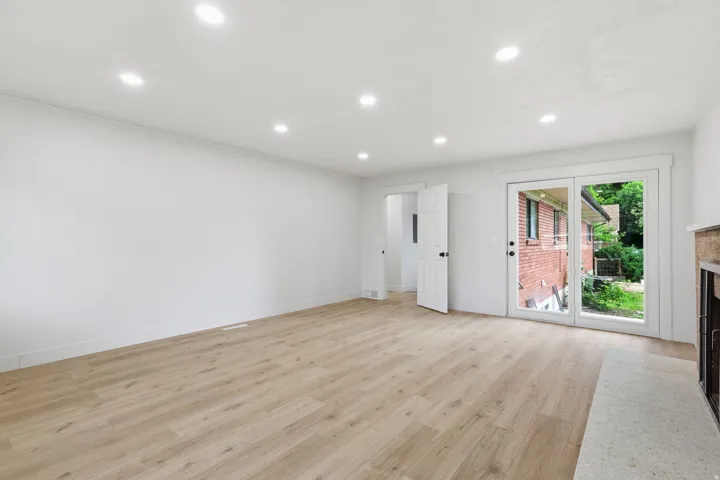Spacious interior with wood-finish flooring, recessed lighting, and a neutral color palette