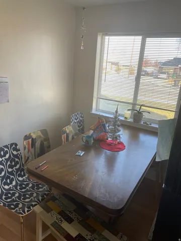 Bright interior space featuring a window with horizontal blinds
