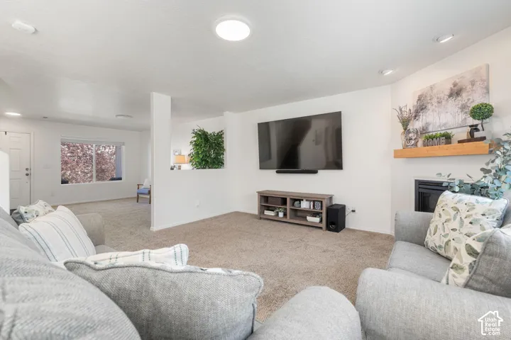 Featuring a built-in fireplace, a wood mantel and accent lighting