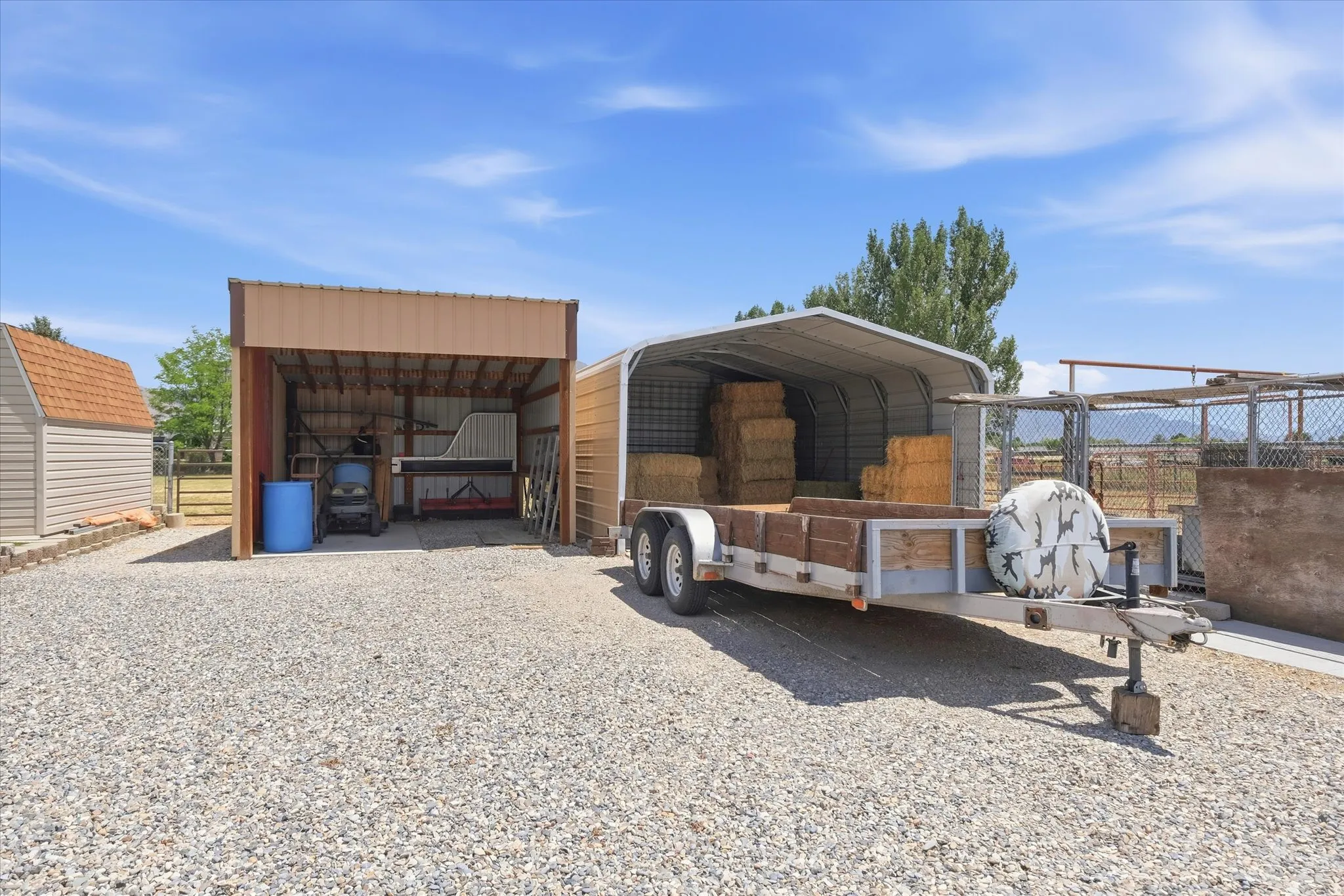 Expansive gravel lot with multiple outbuildings