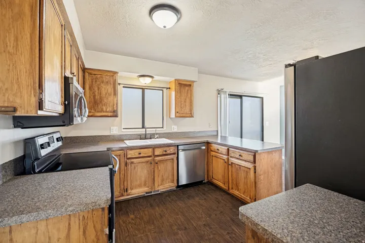 Kitchen featuring wood-finish cabinetry and speckled countertops