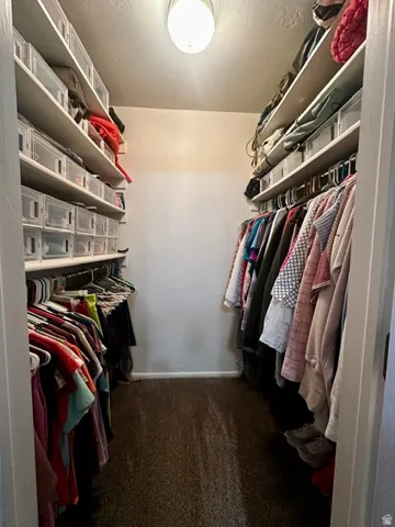 Walk-in closet featuring extensive shelving, hanging rods, and recessed overhead lighting