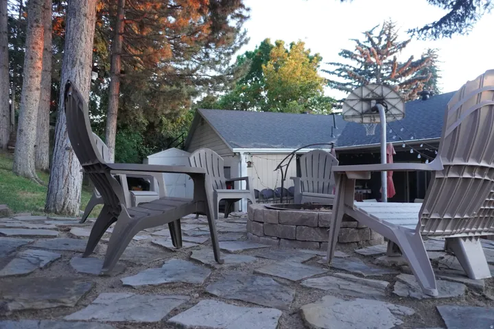 Stone patio featuring a built-in fire pit with stone block surround