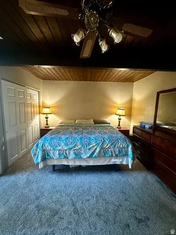 Vaulted wood-paneled ceiling with a brass-finish ceiling fan and integrated lighting