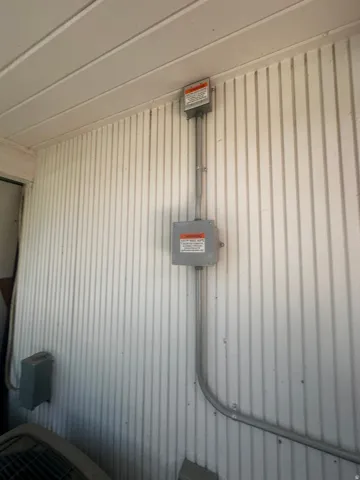 Exterior corrugated wall paneling with conduit and electrical boxes
