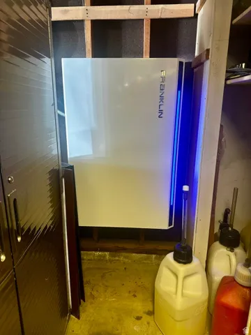 Energy storage system with a sleek white panel and integrated blue lighting