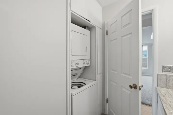 Integrated stackable laundry appliances within a dedicated closet
