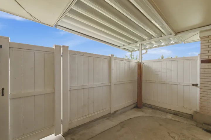 Covered outdoor patio area featuring concrete flooring