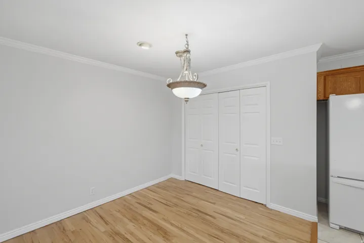 Room featuring wood-finish flooring and light gray walls