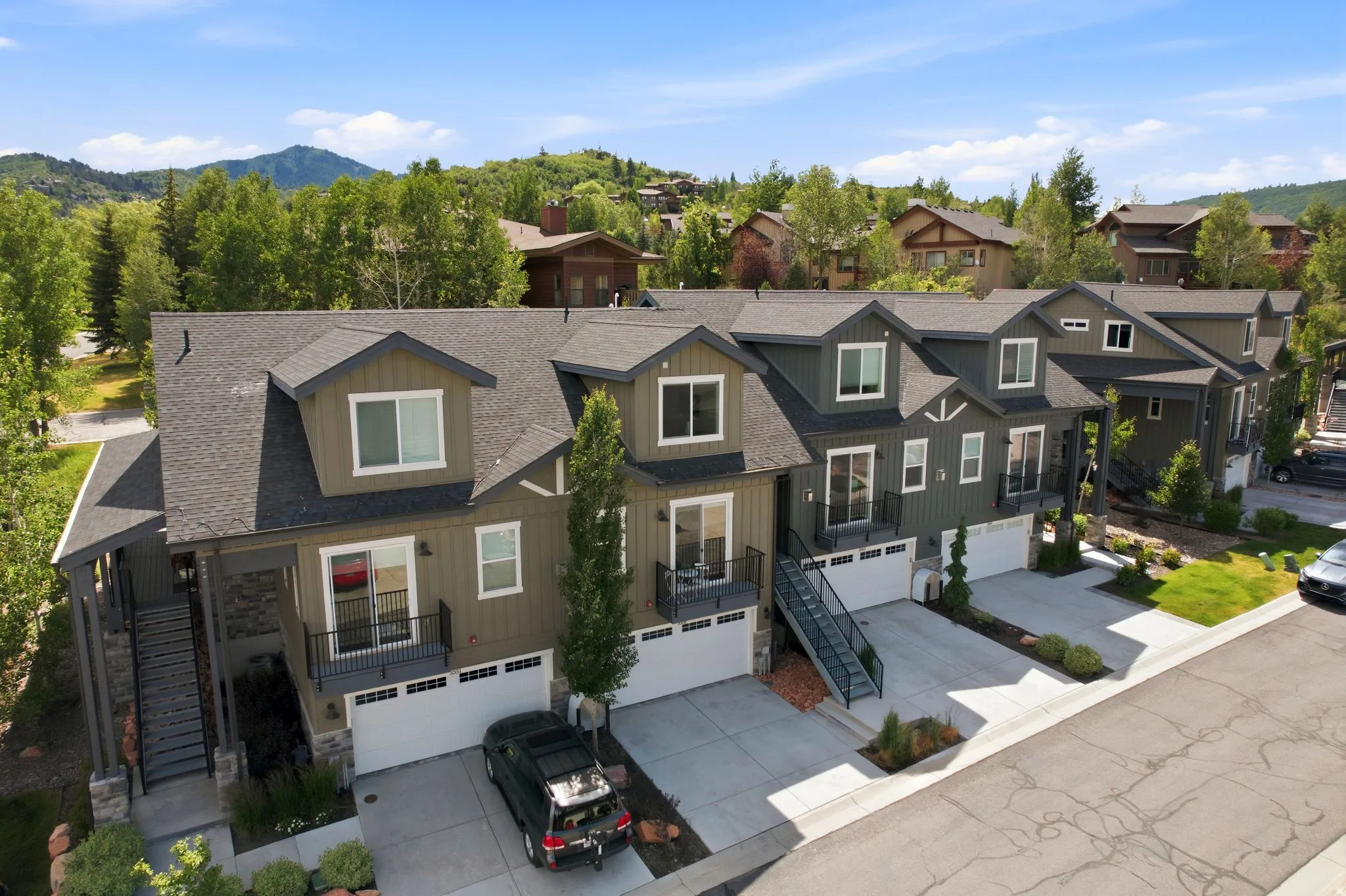 Modern townhome-style residences featuring dark-toned siding and white trim