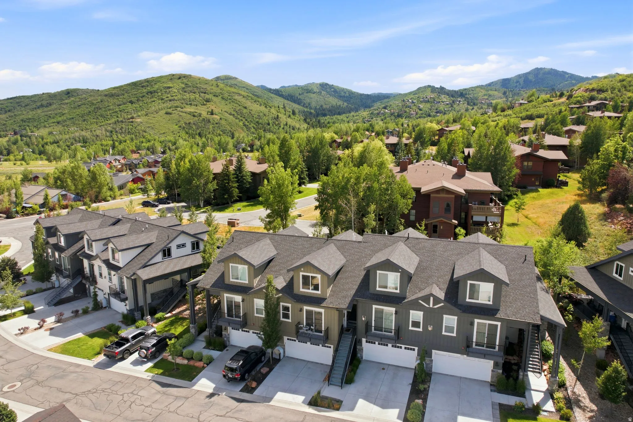 Contemporary townhome community featuring multiple dormer windows and two-car garages