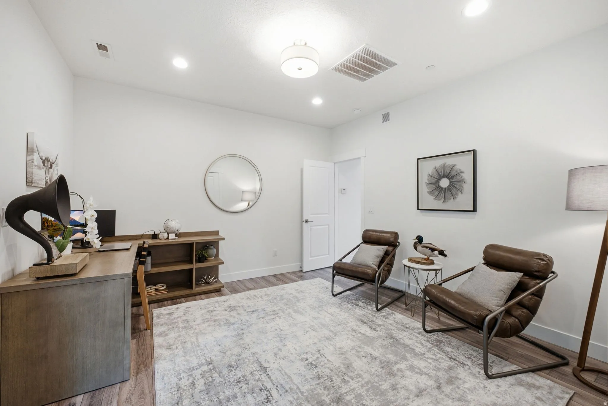 Bright room with wood-finish flooring and recessed lighting