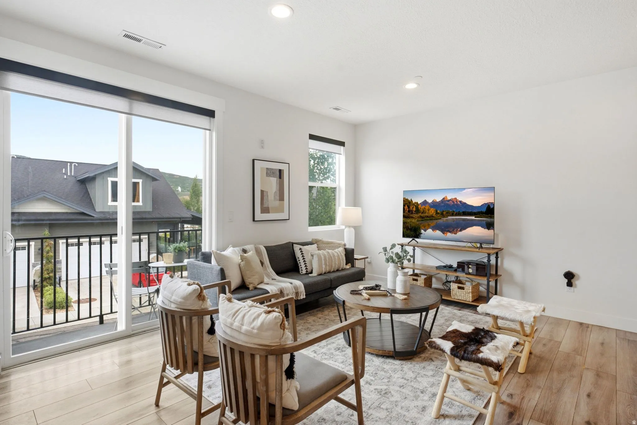 Living area with light wood-finish flooring and white walls