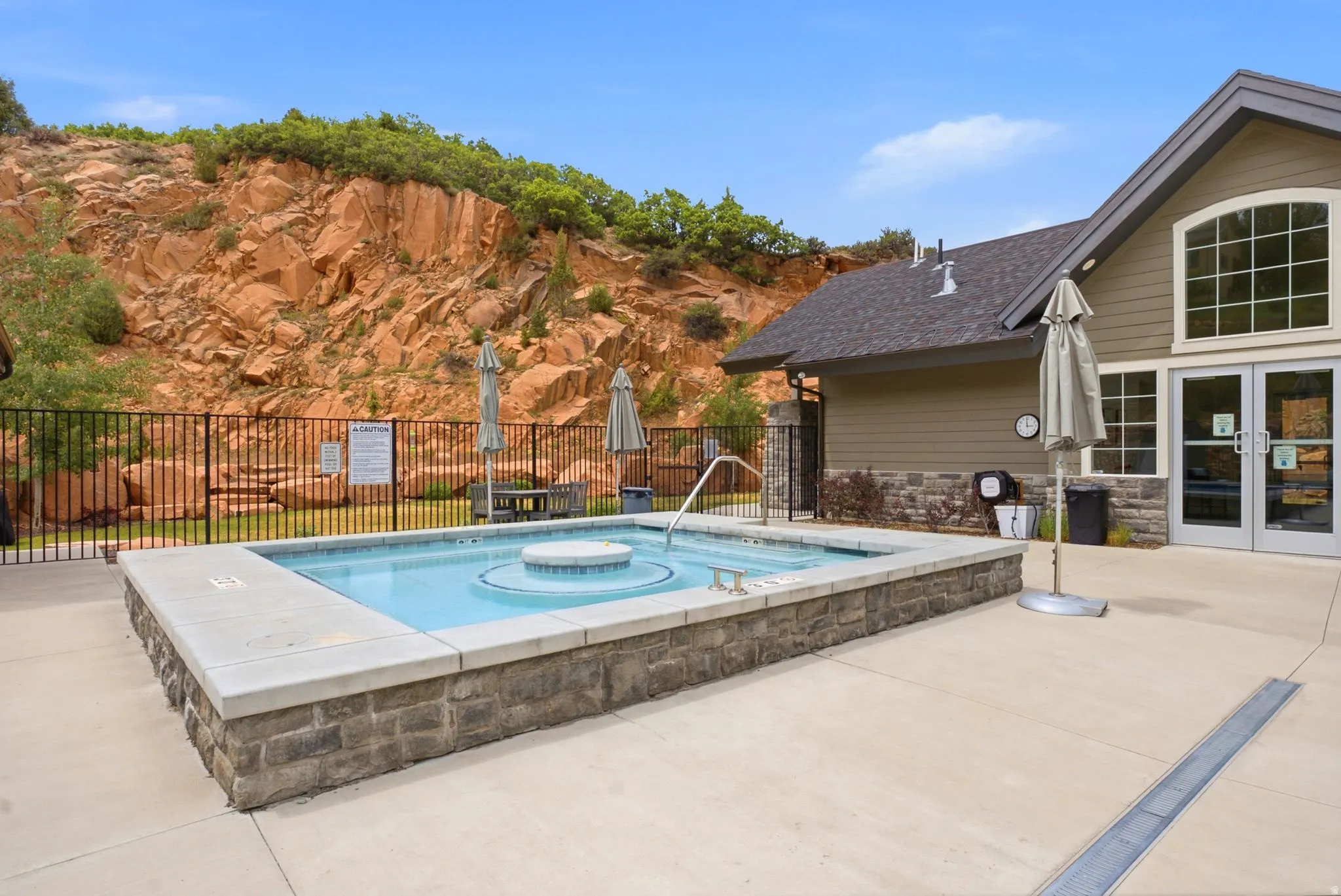 Outdoor water feature with stone-look surround and concrete coping