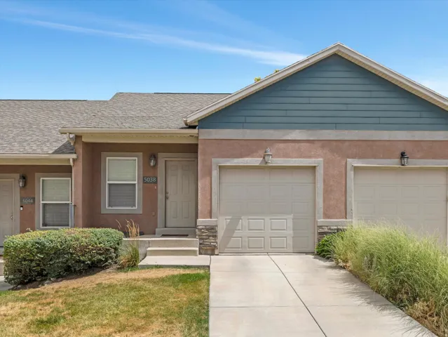 Exterior with a stucco finish and blue siding details