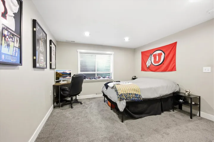 Carpeted room featuring a window with blinds, recessed lighting, and light gray walls
