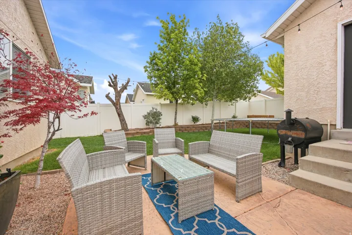 Expansive concrete patio area with integrated steps and string lighting