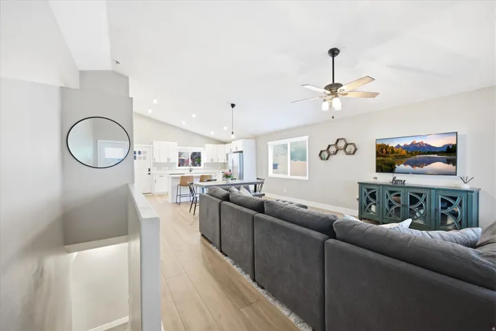 Open-concept living space with vaulted ceilings and wood-finish flooring