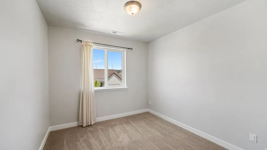 Neutral wall tones with a single window providing natural light
