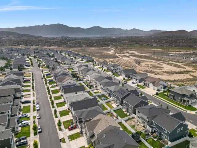 Residential neighborhood featuring detached homes with varied architectural styles, asphalt shingle roofs, and landscaped front yards