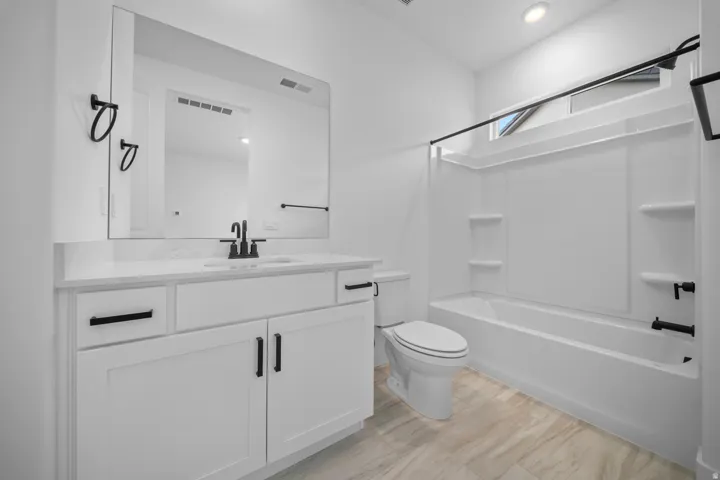Casita Modern bathroom featuring a white vanity with a quartz-look countertop, rectangular sink, and matte black fixtures