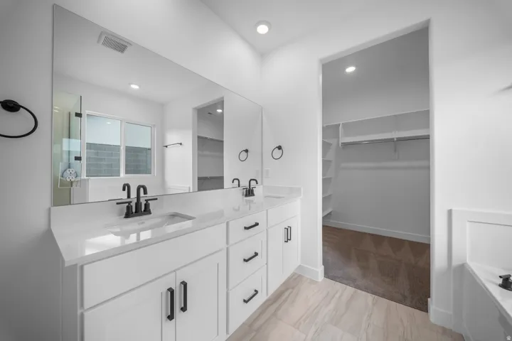 Dual vanity with quartz countertops, undermount sinks, and matte black fixtures