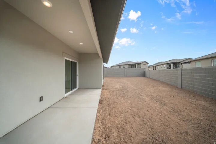 Expansive backyard with a block wall perimeter and a large patio area
