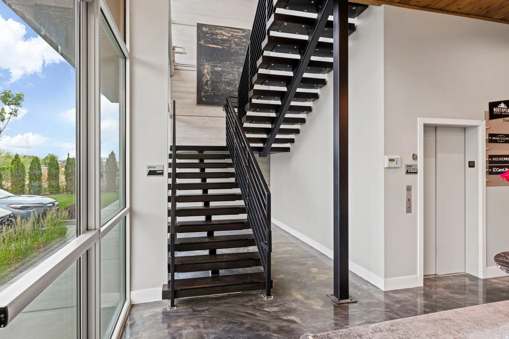 Industrial-style staircase with open risers and metal railings