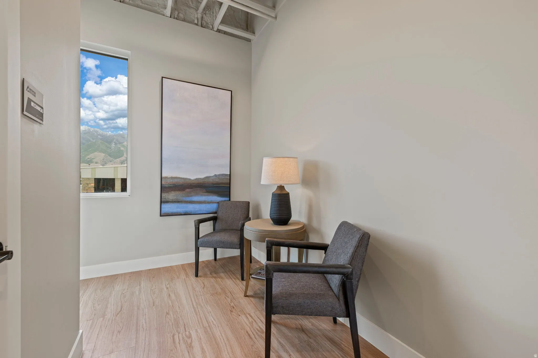 Light wood-finish flooring complements the neutral wall color
