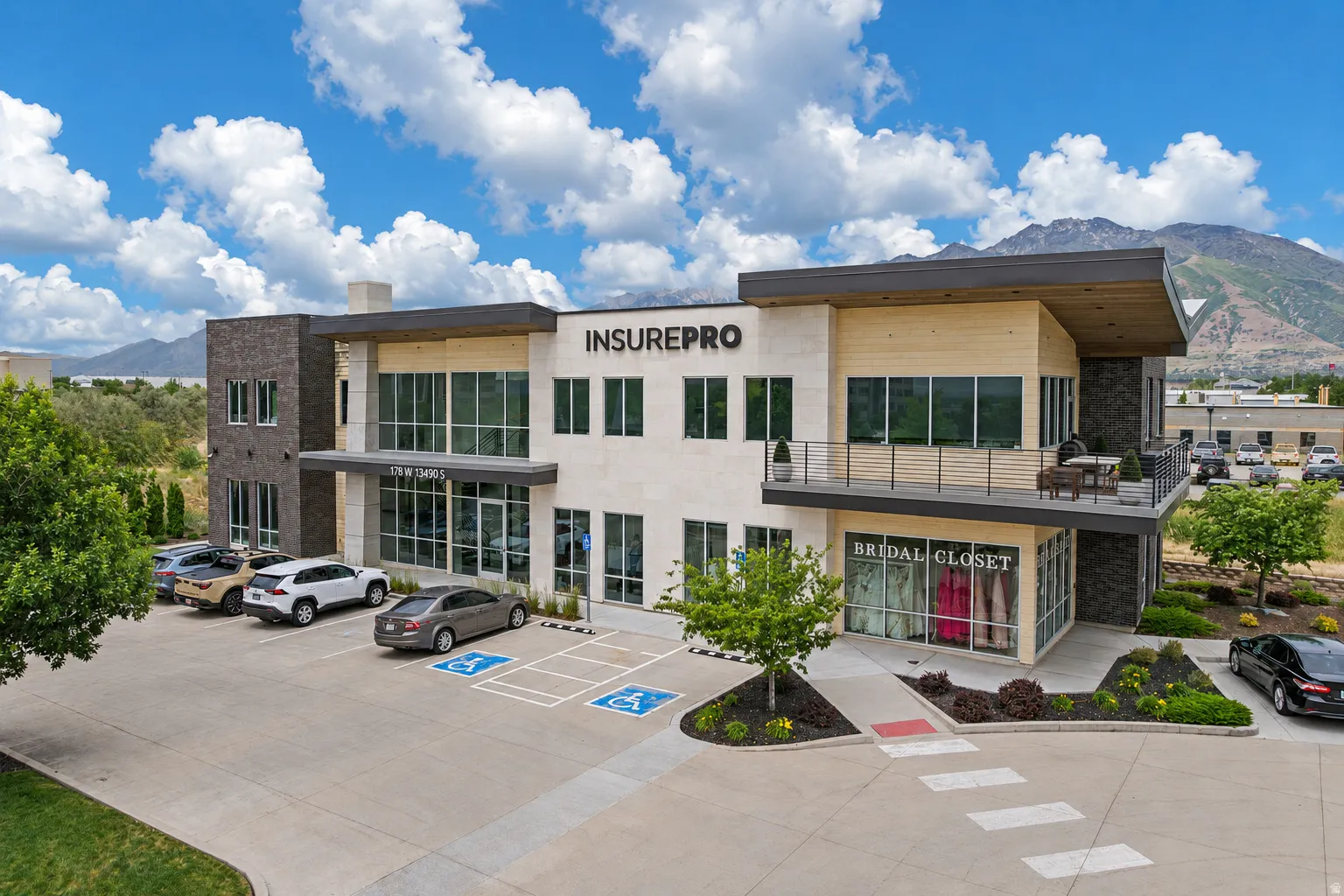 Modern commercial building featuring a multi-textured facade including stone, stucco, and wood-finish paneling
