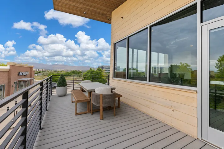 Expansive balcony featuring composite decking and a black metal railing