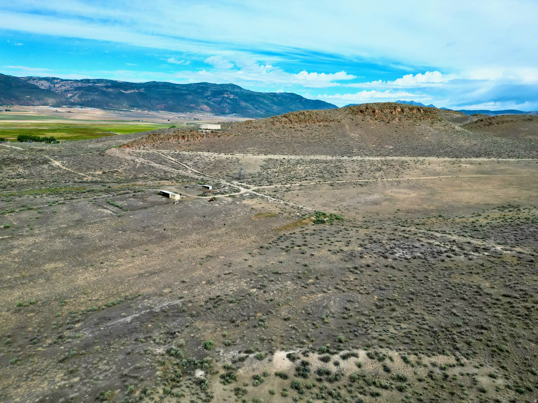 Expansive undeveloped terrain featuring a mix of scrubland and natural vegetation