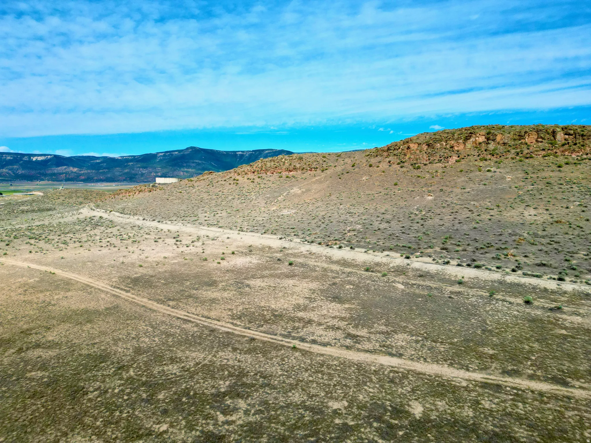 Expansive undeveloped landscape featuring a gently sloping terrain
