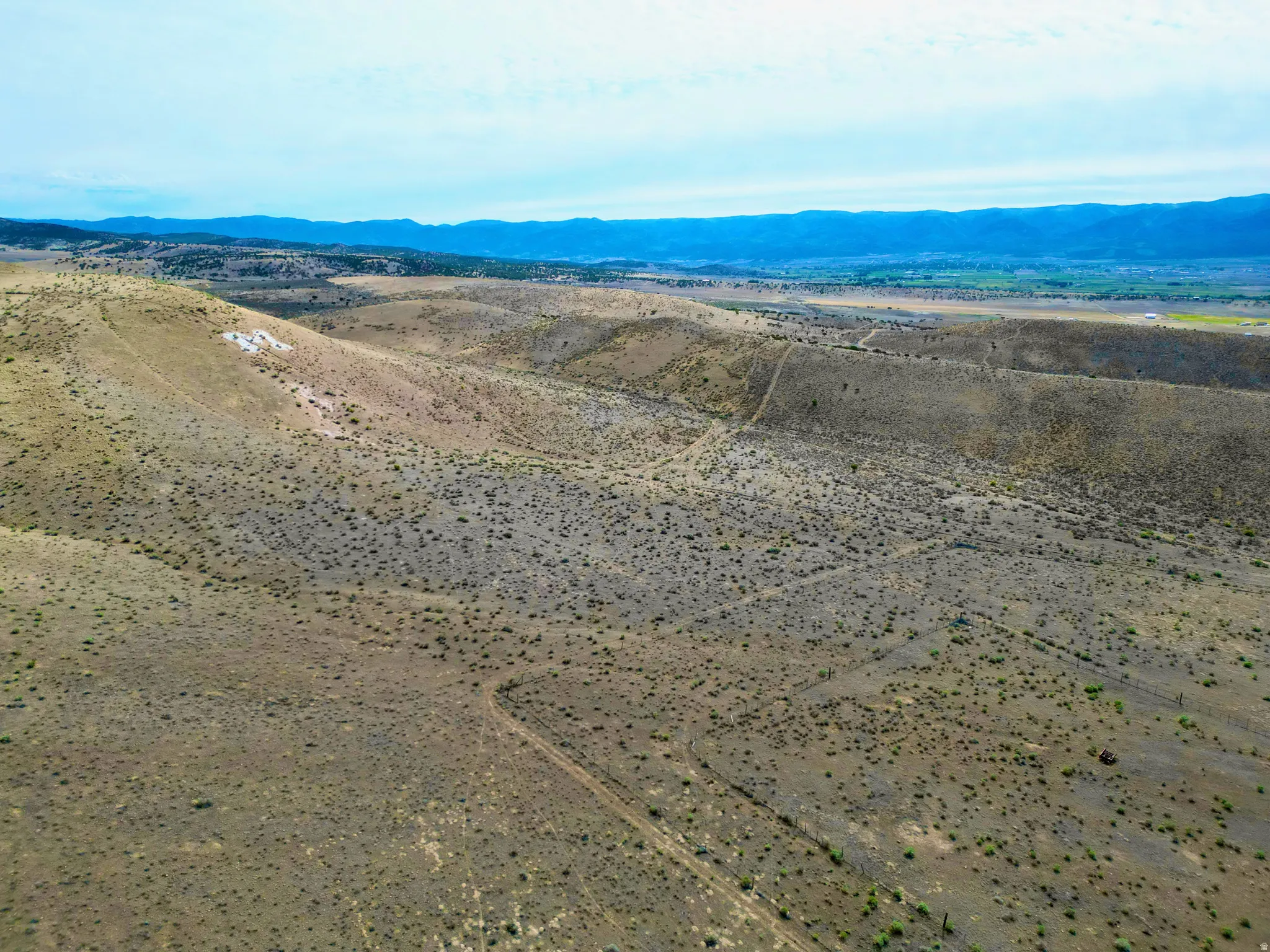 Vast undeveloped acreage featuring undulating terrain and sparse natural vegetation