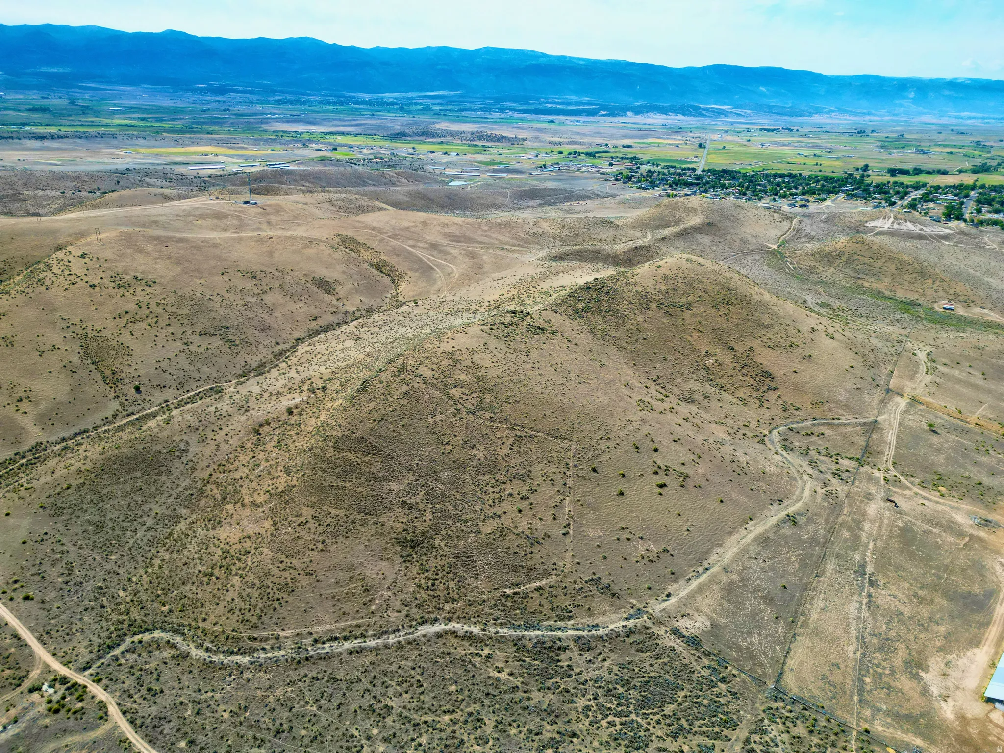 Expansive undeveloped land featuring varied terrain and distant mountain ranges