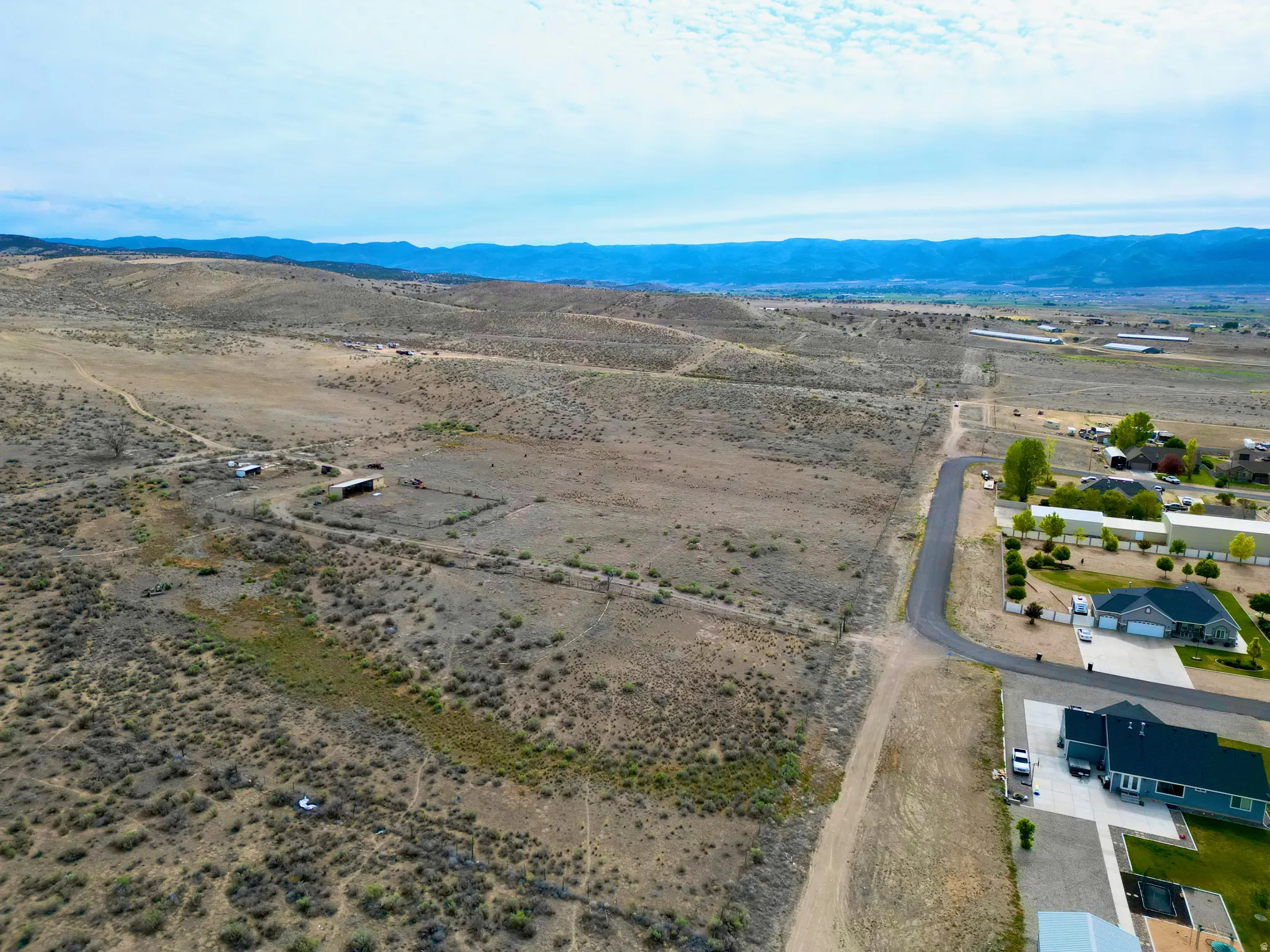 Expansive rural acreage featuring distant mountain ranges and scattered brush