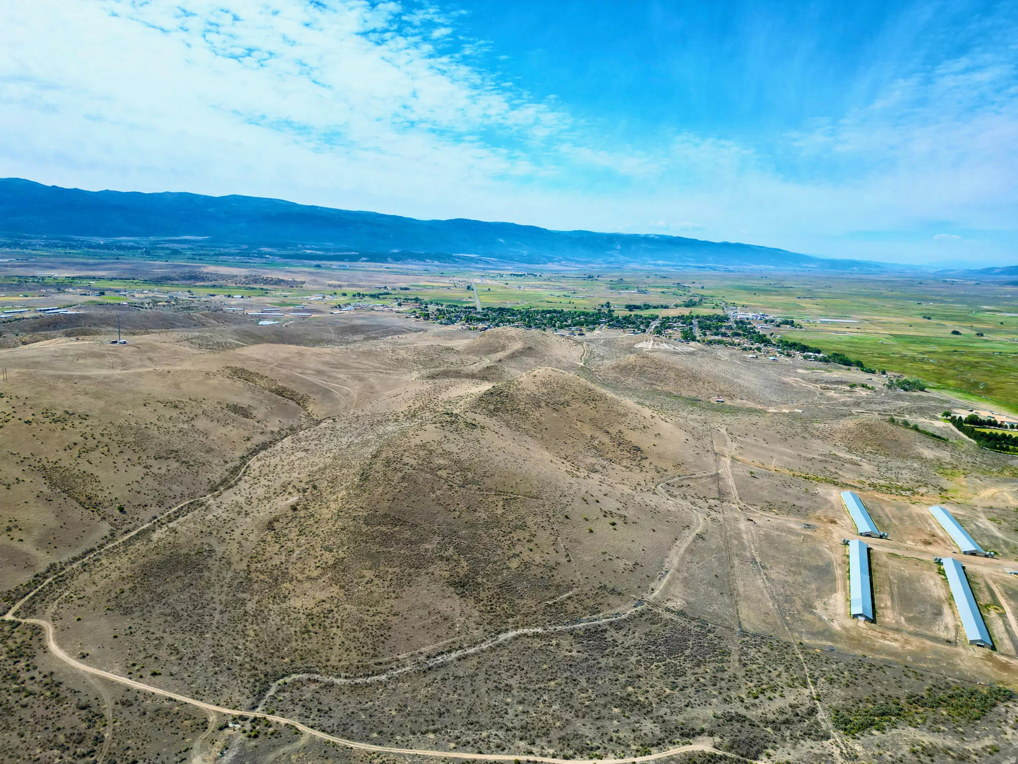Expansive acreage featuring rolling hills, varied terrain, and distant mountain ranges