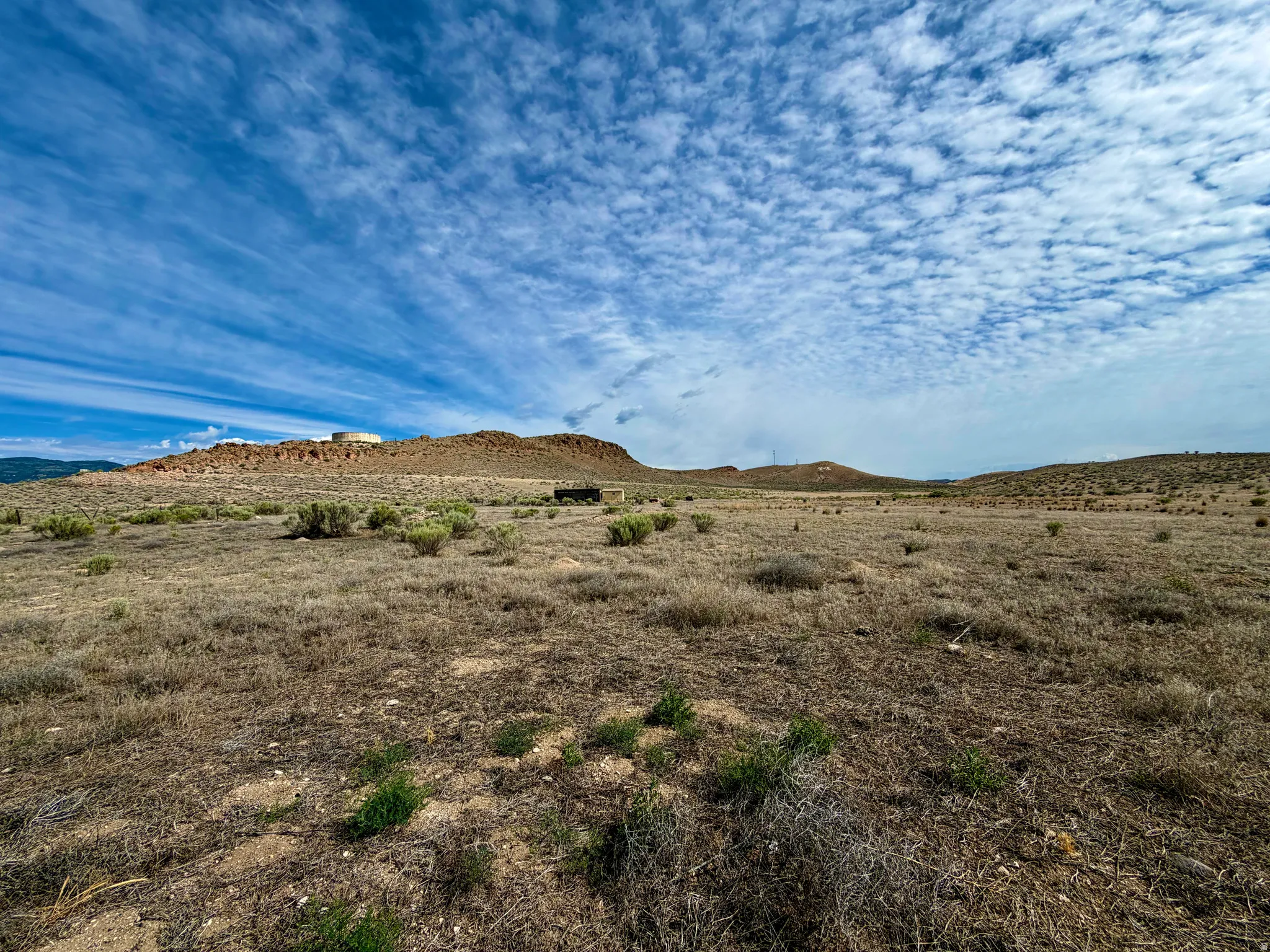 Expansive land parcel featuring natural desert landscaping and distant mesa formations