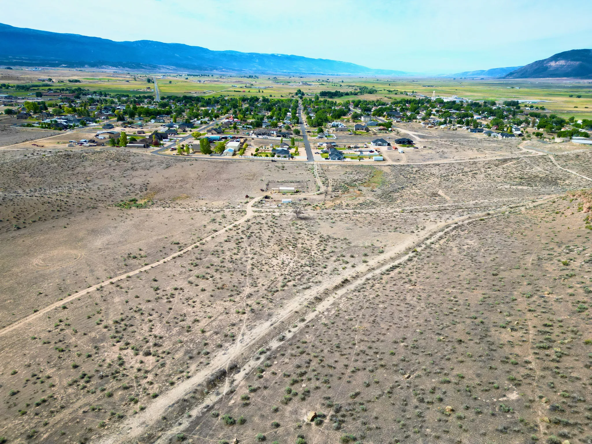 Expansive undeveloped land with visible dirt paths
