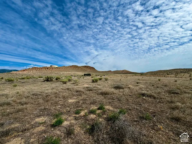 Expansive land parcel featuring natural desert landscaping and distant mesa formations