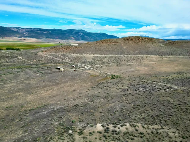 Expansive undeveloped terrain featuring a mix of scrubland and natural vegetation