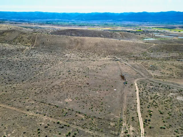 Expansive, undeveloped parcel featuring varied topography and distant mountainous terrain