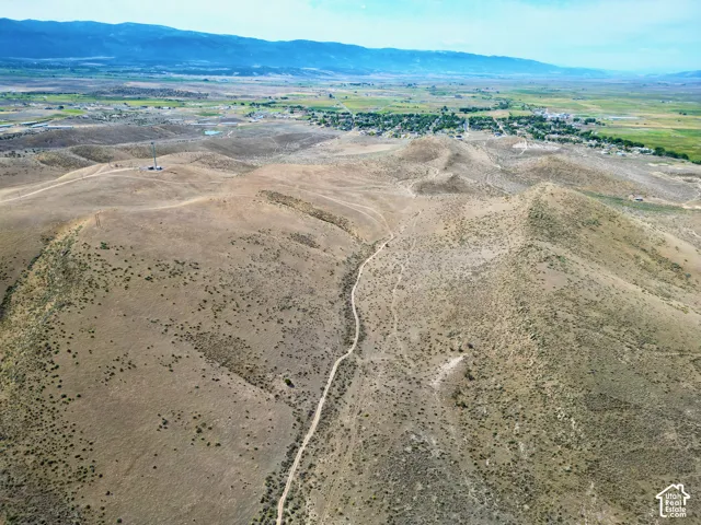 Expansive undeveloped terrain featuring a winding dirt path and sparse vegetation