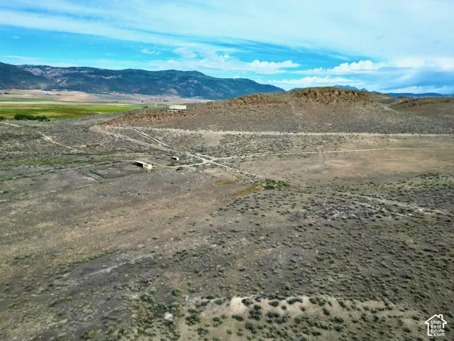 Expansive undeveloped terrain featuring a mix of scrubland and natural vegetation