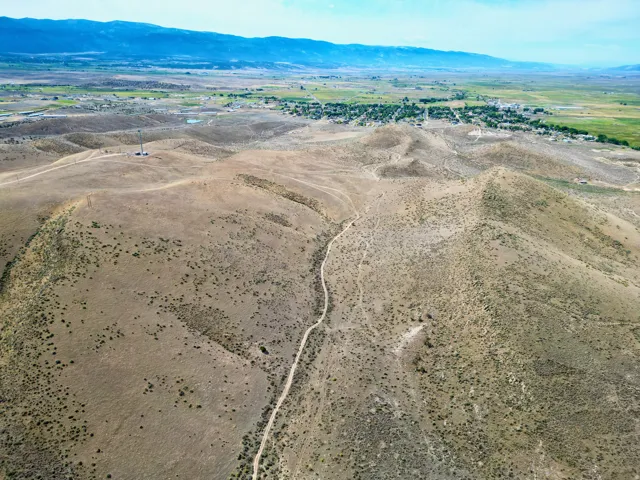 Expansive undeveloped terrain featuring a winding dirt path and sparse vegetation