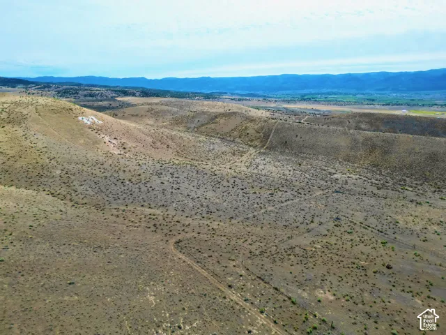 Vast undeveloped acreage featuring undulating terrain and sparse natural vegetation