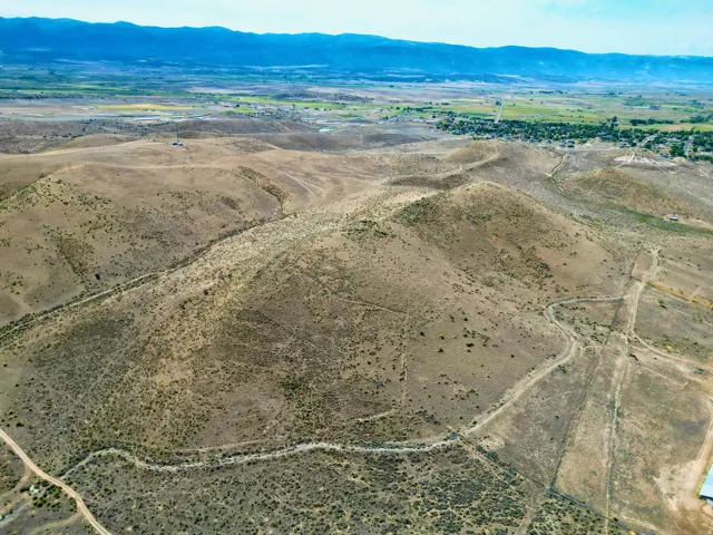 Expansive undeveloped land featuring varied terrain and distant mountain ranges