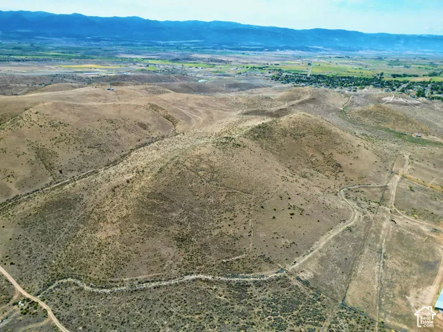 Expansive undeveloped land featuring varied terrain and distant mountain ranges