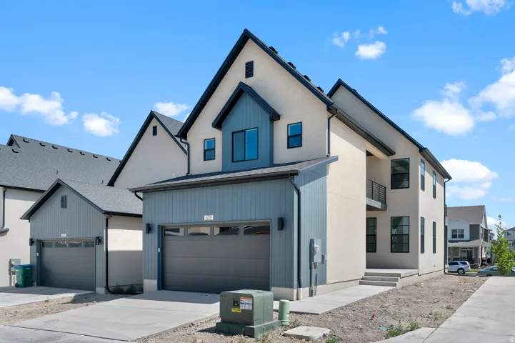 Contemporary exterior with light stucco and blue siding accents